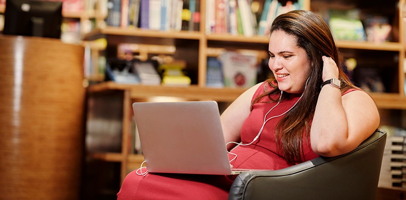Woman with Earphones Watching Video