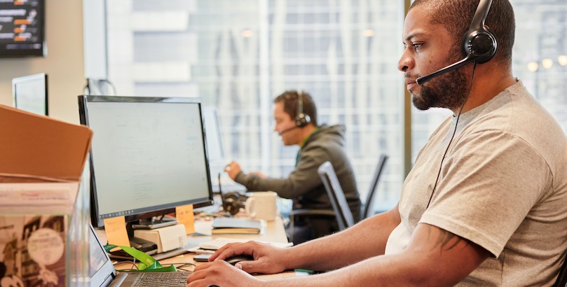 Man wearing headset working on computer