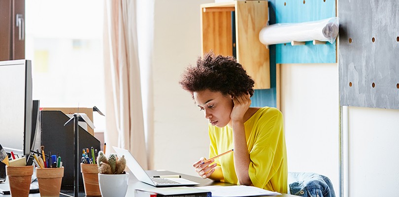 Woman working at her desk alone