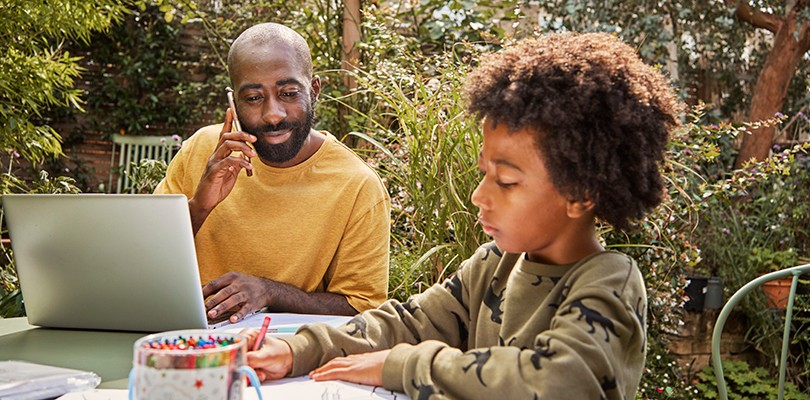 Man and son working together outside on table