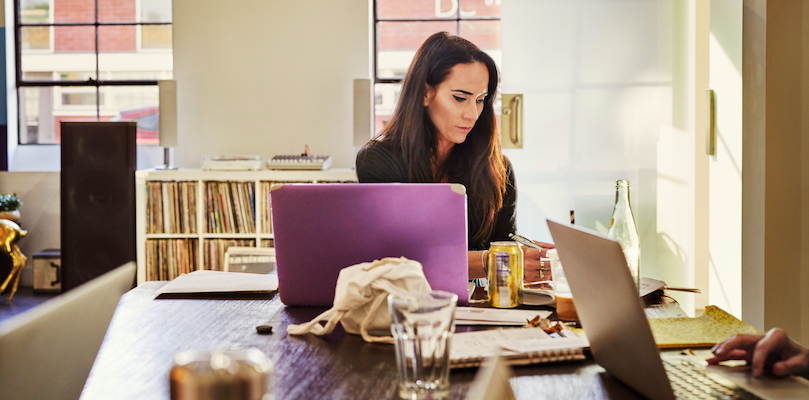 Woman sitting at desk in front of computer