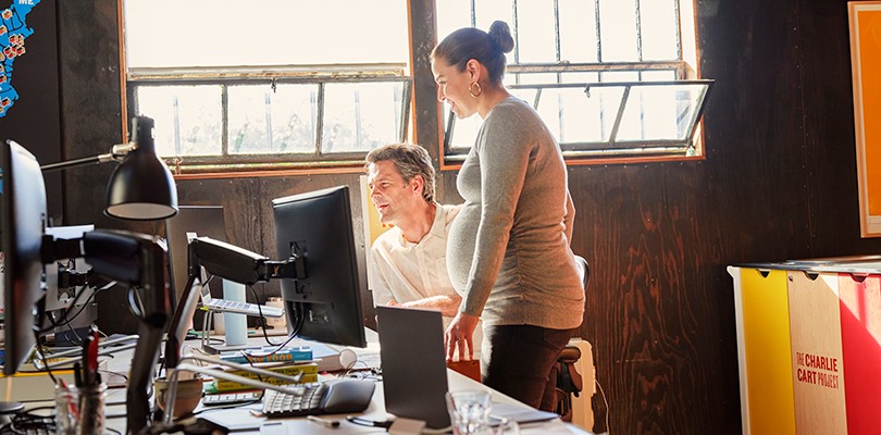 Man and pregnant woman looking at a monitor