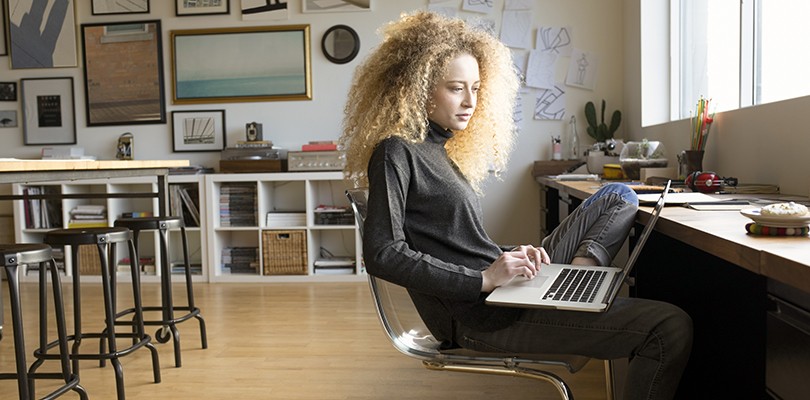Young woman using laptop in classroom
