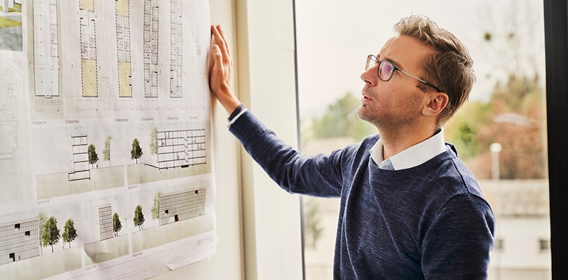 Man looking at chart on white board