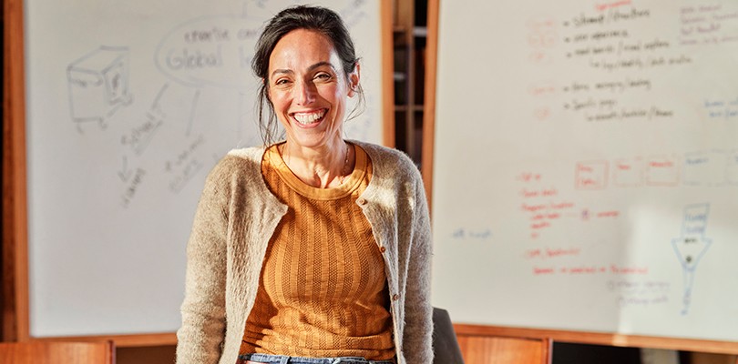 Woman smiling alone in a meeting room
