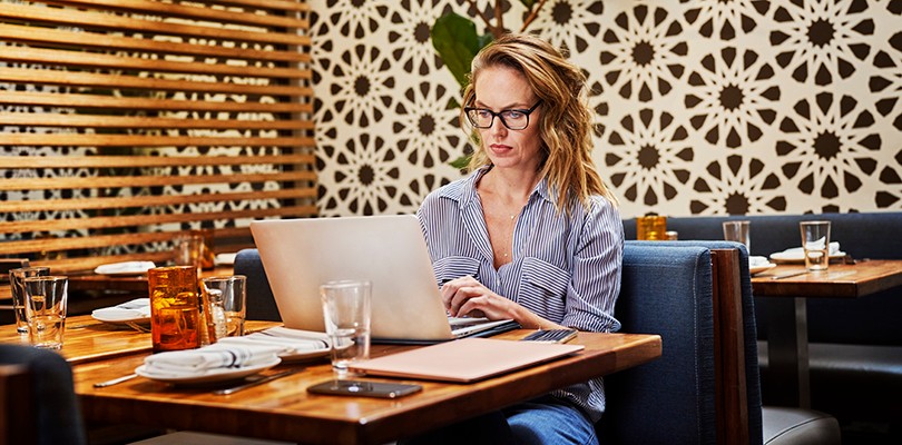 Woman working at on a laptop at a table