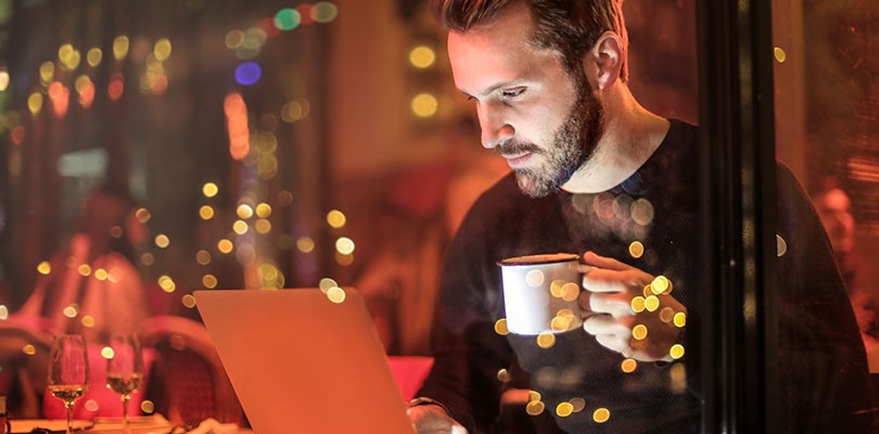 Man Holding Mug at Cafe