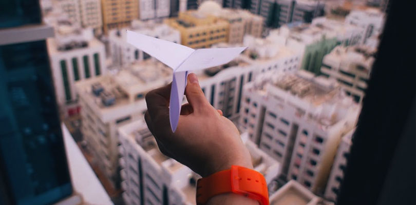 Throwing paper airplane out window