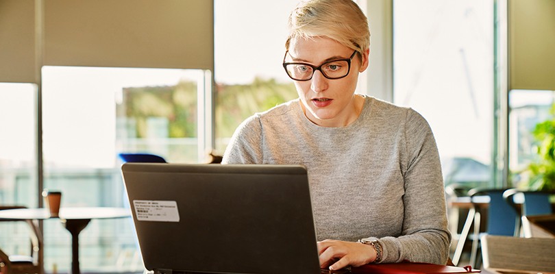 Woman working in café on laptop