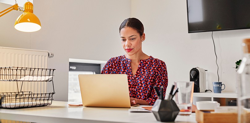 Woman at desk working alone