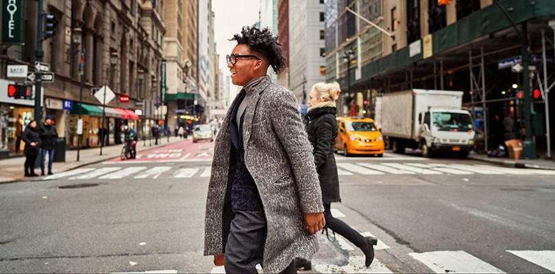 Man crossing busy city street