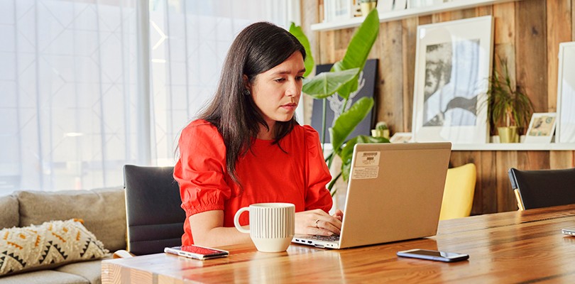 Woman at a table working on laptop