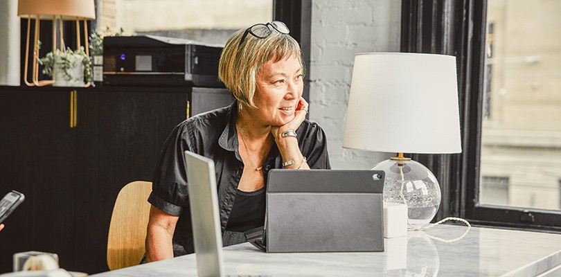 Woman at a desk with a tablet