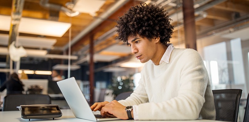 Man working in an office on a laptop