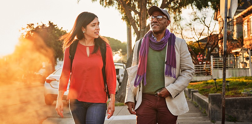 Man and woman walking in a neighborhood