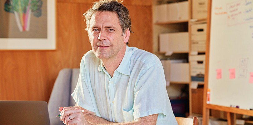 Man sitting in front of a laptop in an office