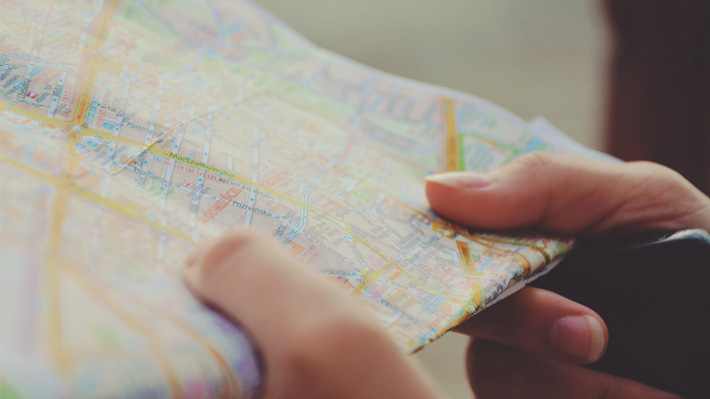 Close up of Two Hands Holding an Open Map