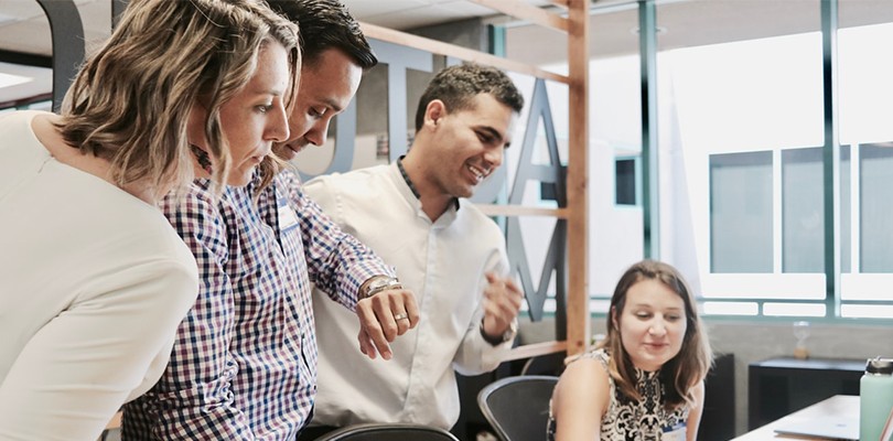 Teammates Working Together in Office