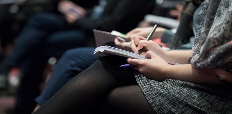 Business Professionals Taking Notes at Sales Conference