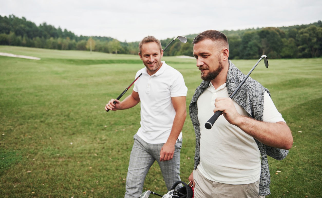 Photo of two men playing golf