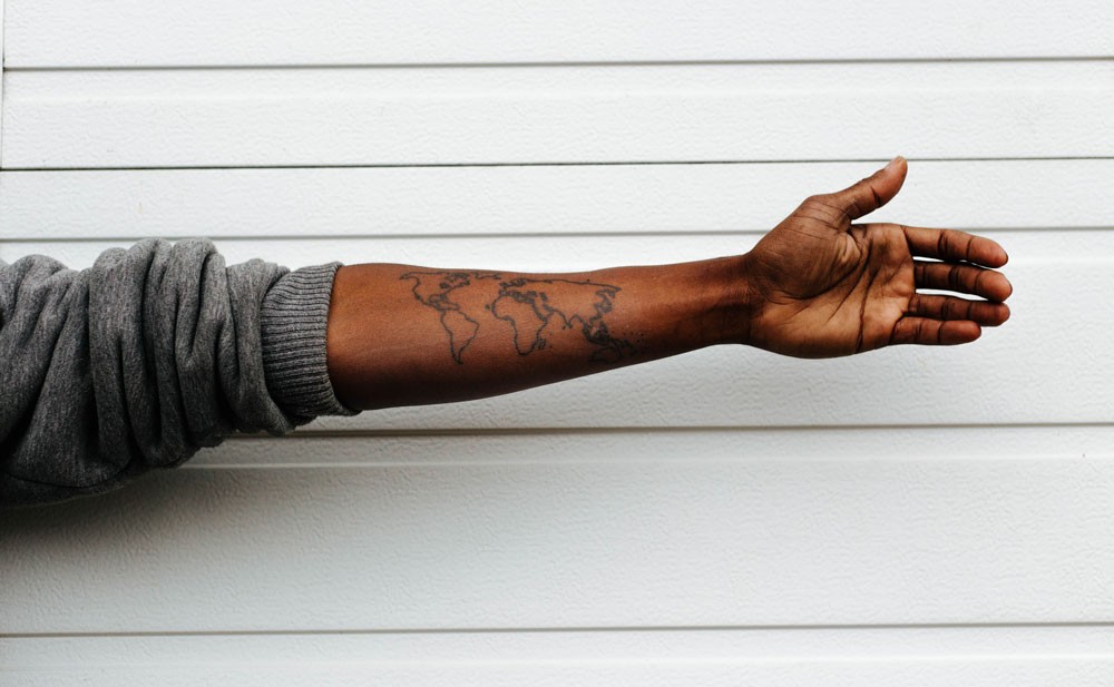 Image of arm with world map tattoo