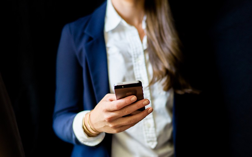 Image of woman looking at her phone