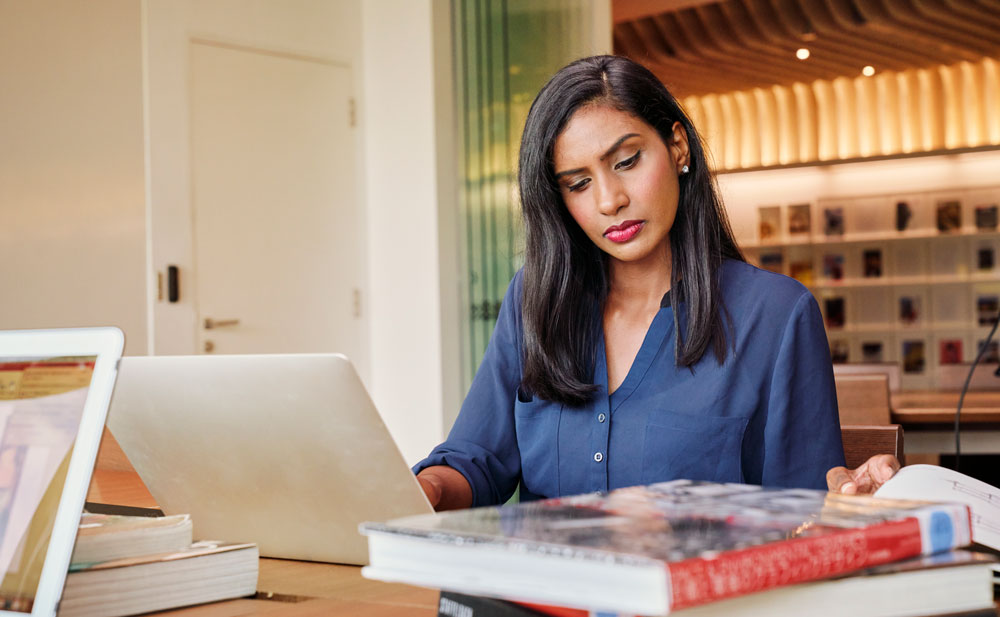 woman taking notes at desk