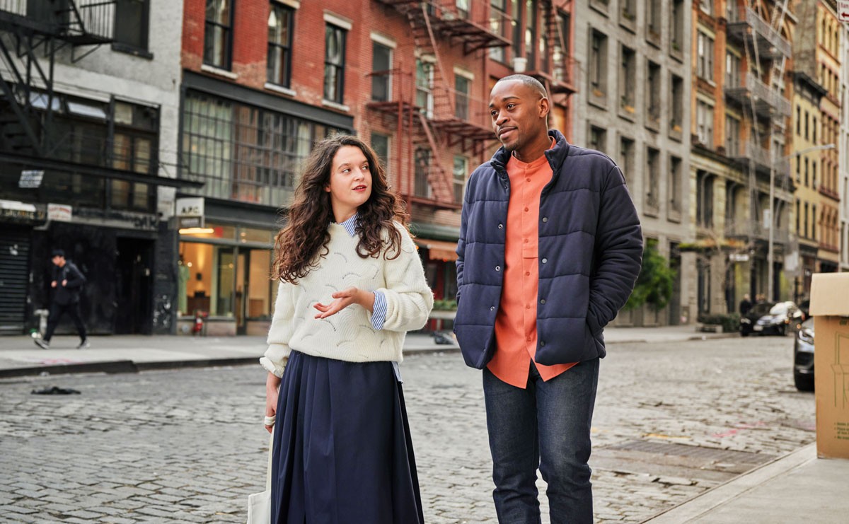 Photo of two people walking and talking outside