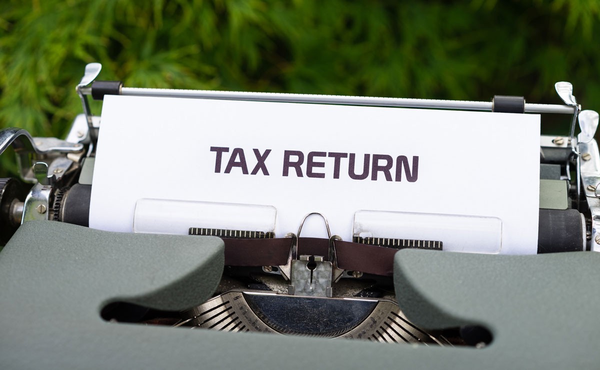 Photograph of typewriter that's typed out "tax return"