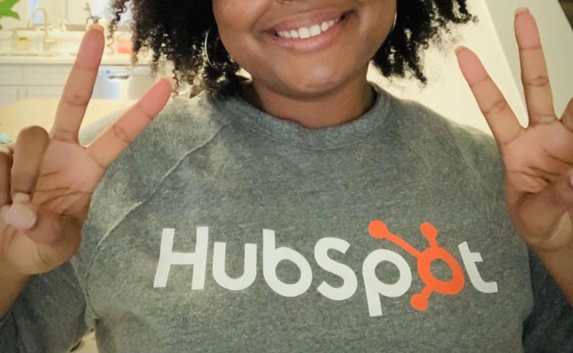 Photo of woman wearing HubSpot sweatshirt