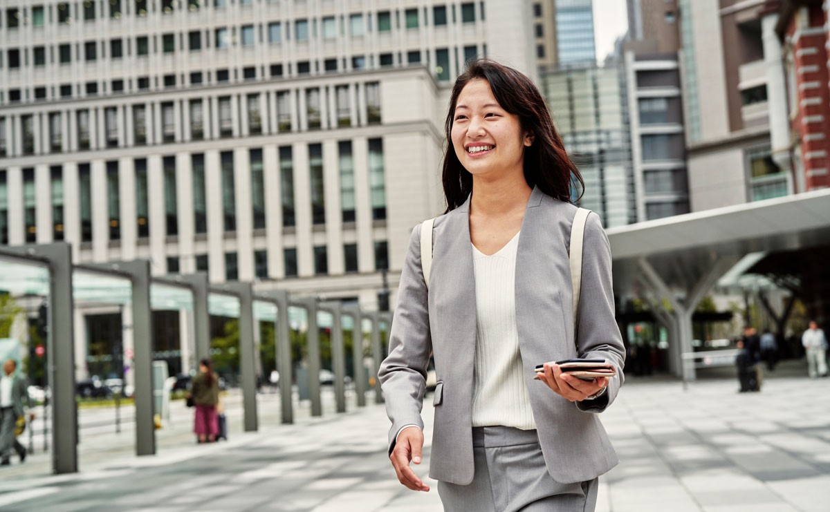Photo of smiling woman walking outside