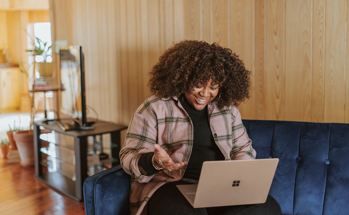 Photo of woman talking into laptop and answering remote interview questions