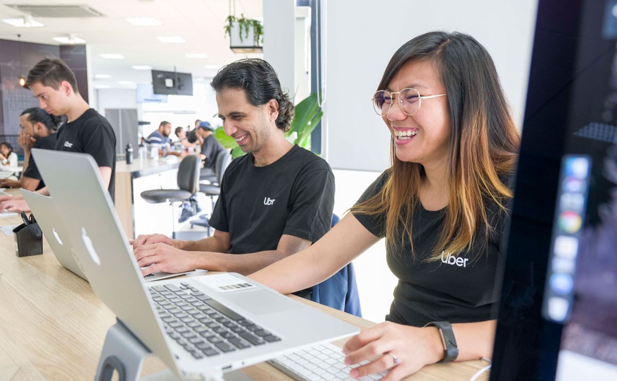 Photo of Uber employees working at their desks