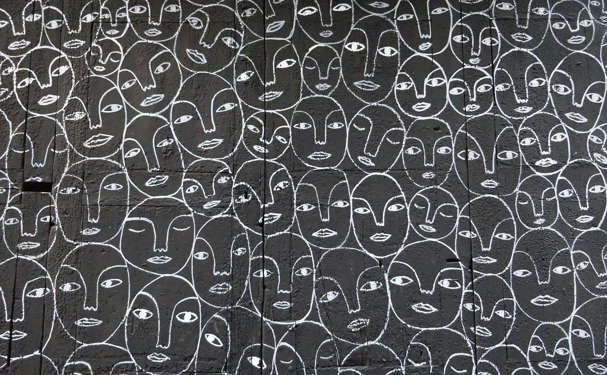 Photo of drawing of many similar looking faces