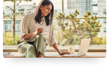 person studying on a laptop in a park