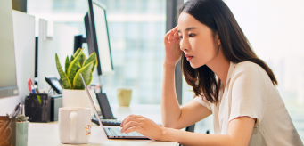 Image of a professional working on a laptop