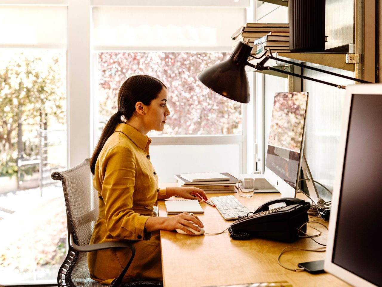woman sitting at desk looking at computer monitor