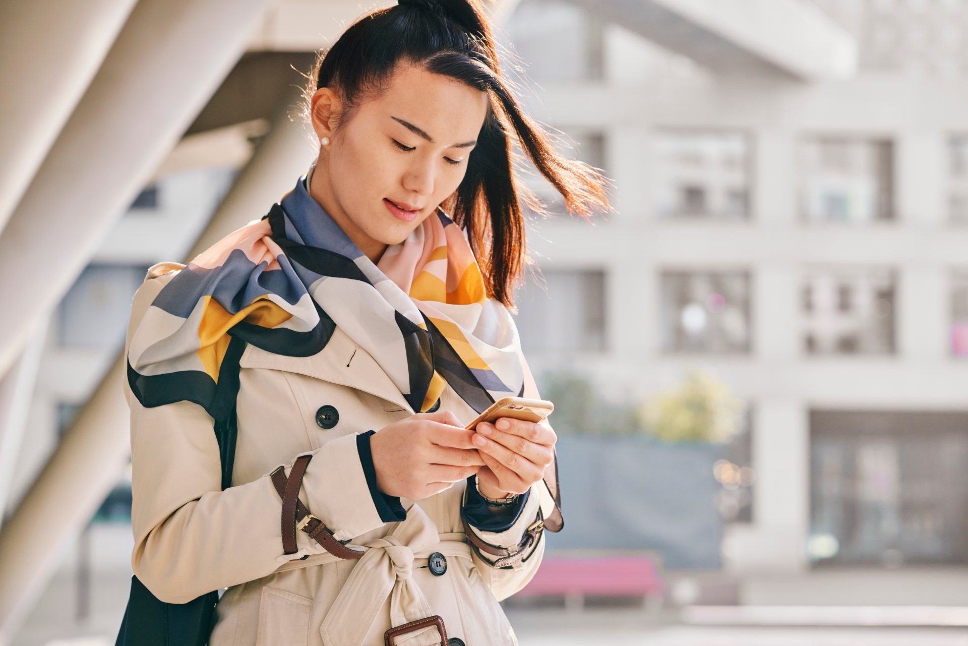 woman walking looking at phone