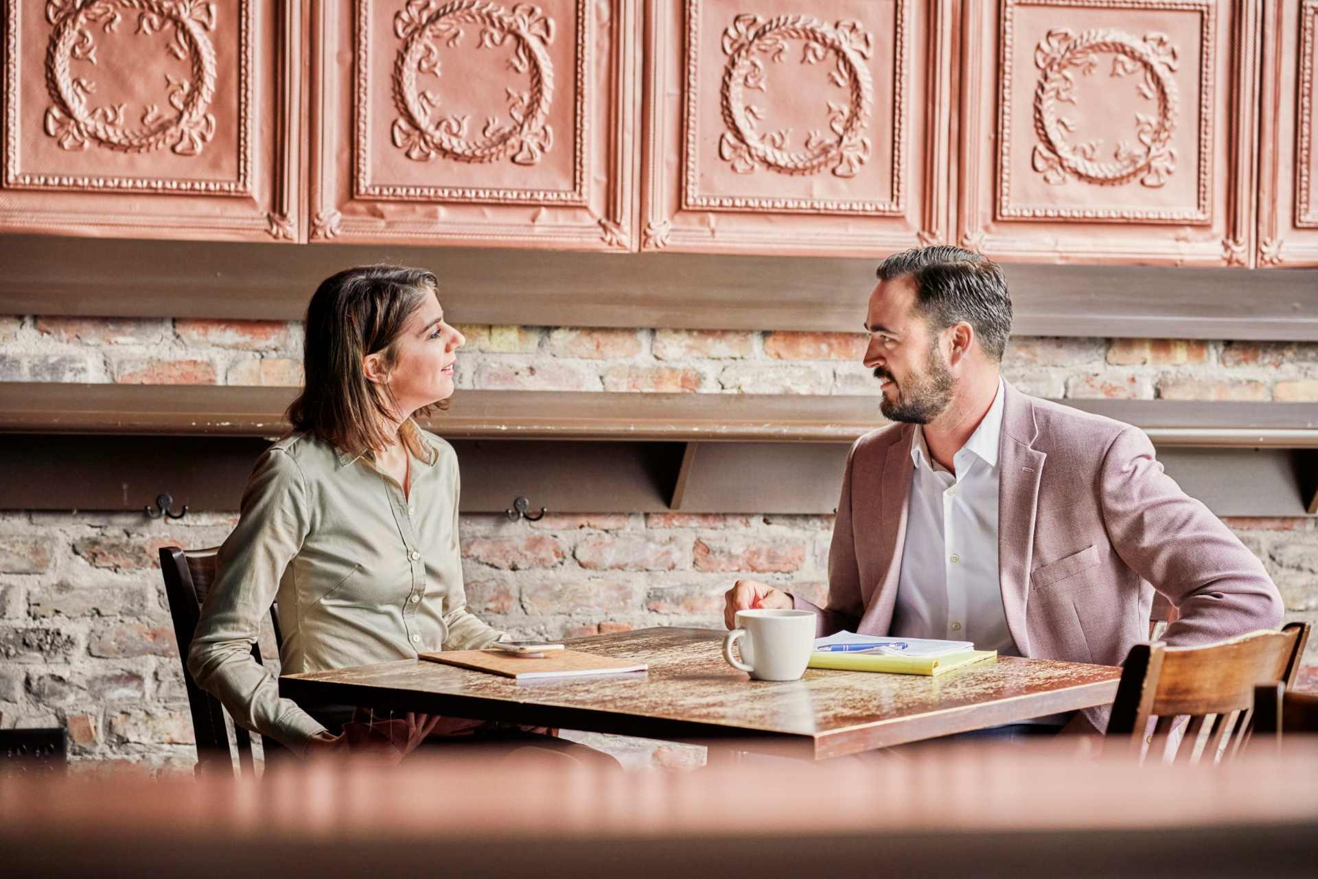 2 people talking at a coffee shop
